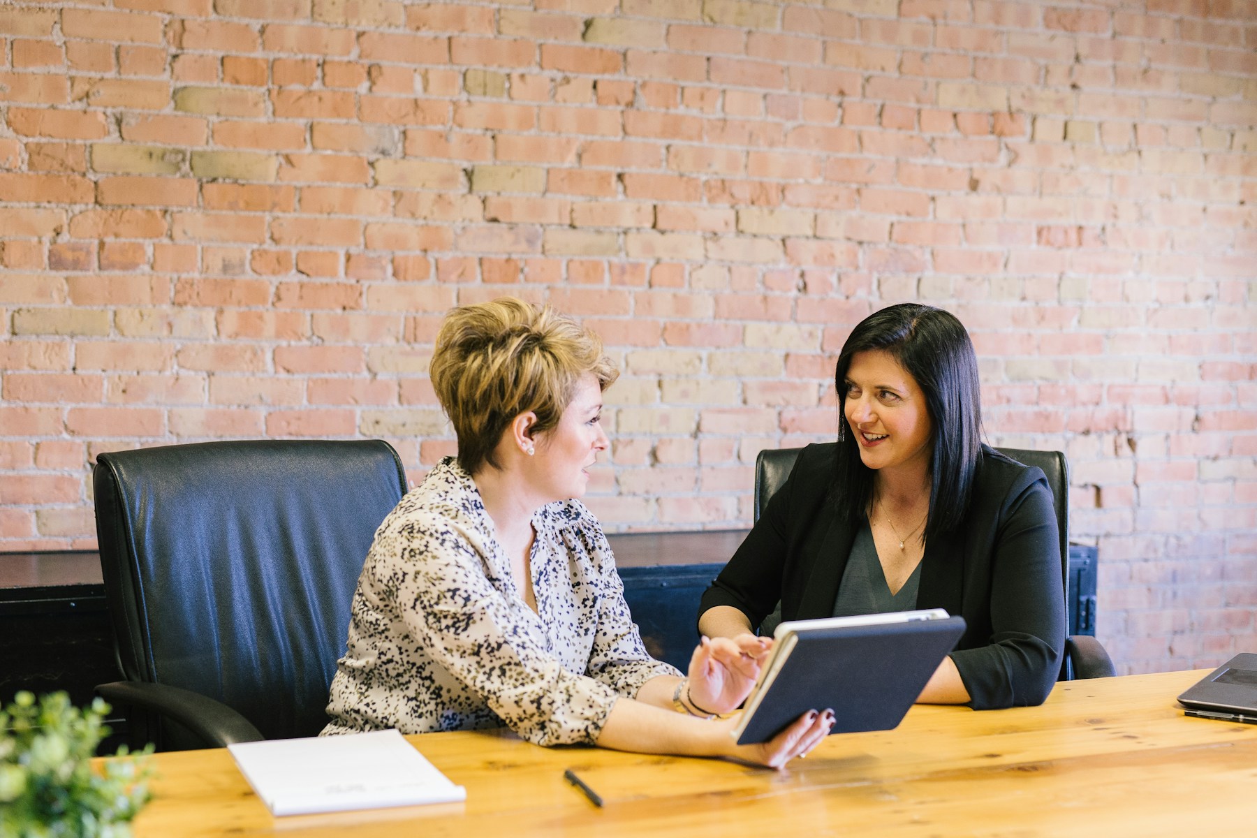 Two people having a business conversation at a table